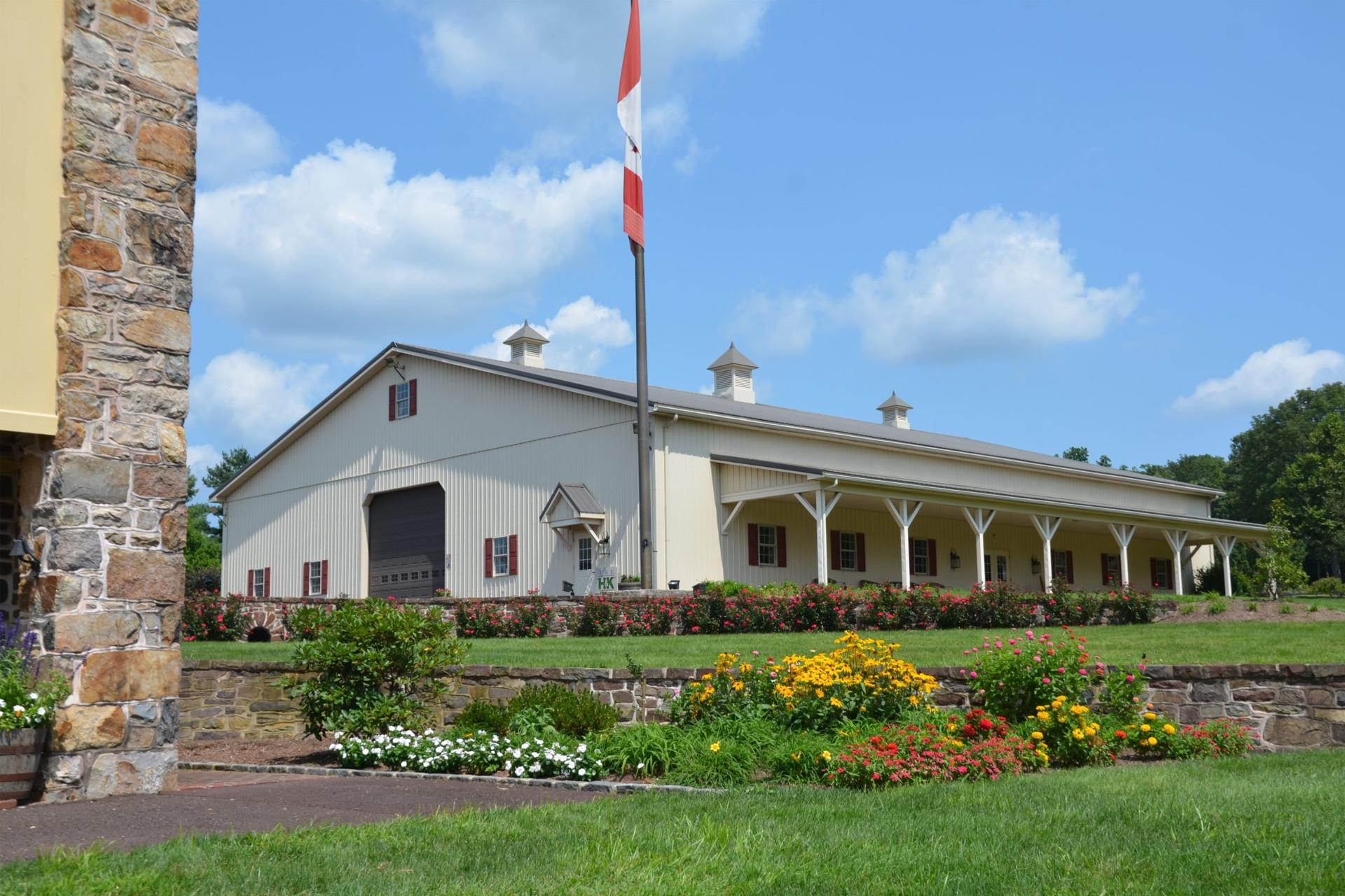 The museum building with cupolas behind stone walls and summer gardens