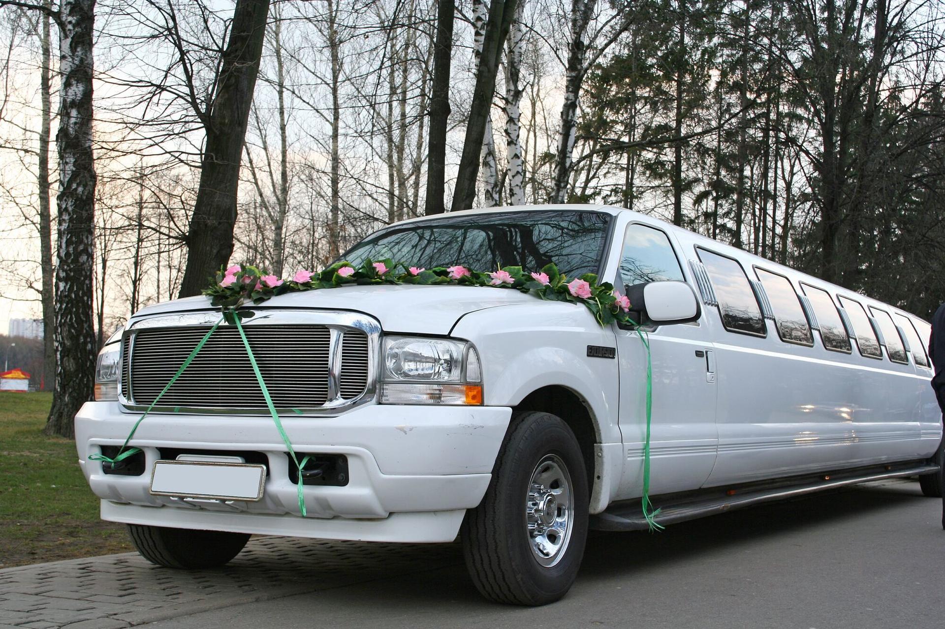 A white stretch limousine decorated for a wedding